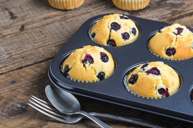 Blueberry Muffins With Powdered Sugar And Fresh Berries