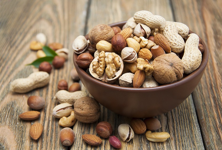 Mixed Nuts In A Bowl On A Wooden Background